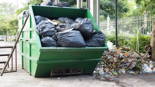 Crew loading mixed commercial waste from a retail back room in Borehamwood